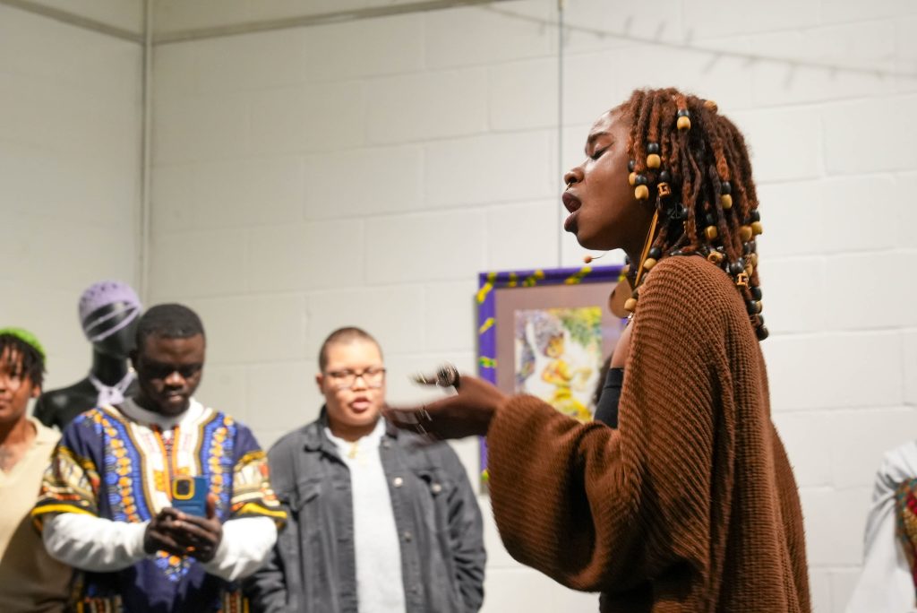 A woman singing in the art gallery.