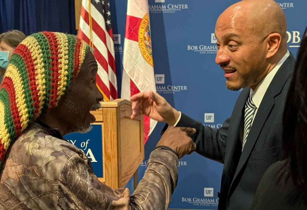 Attendee talking excitedly with guest speaker Dr. Hasan Jefferies.