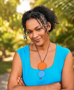 Photo of Dionne Champion wearing blue and smiling at the camera
