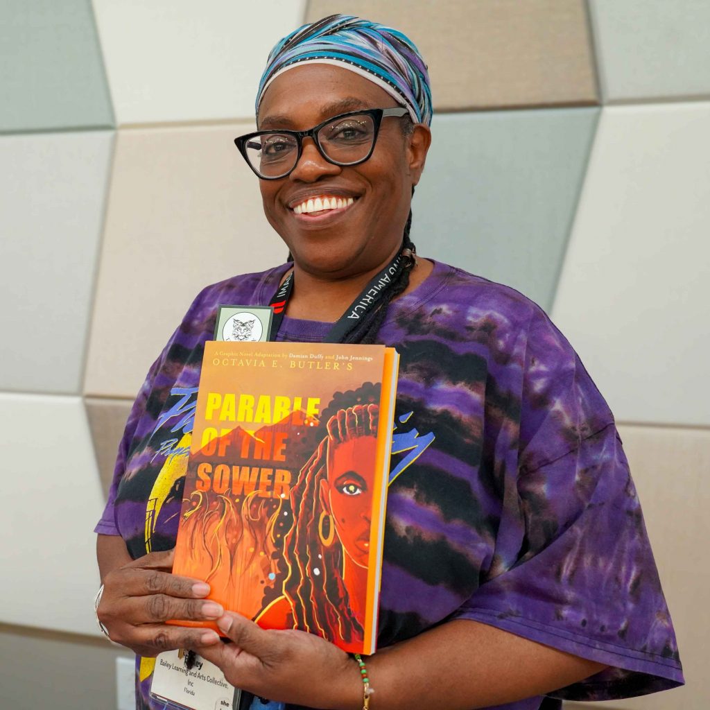 Committee member Terri Bailey holding a book